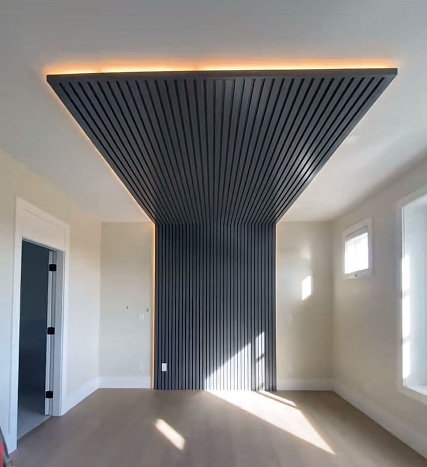 Dark ceiling with recessed spotlights above a corridor and feature wall