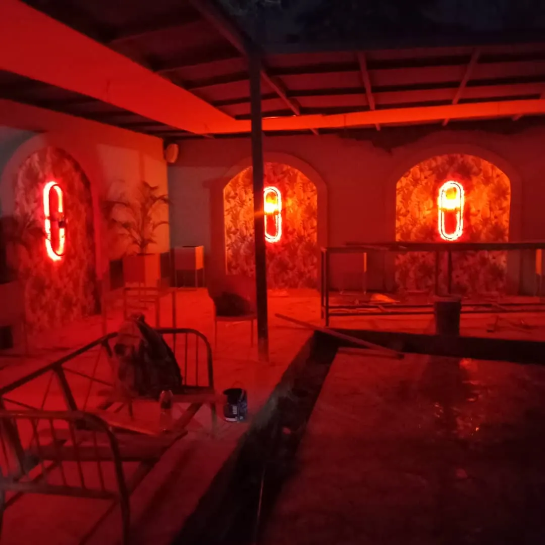 Terrace with arched wall niches lit in deep red at night