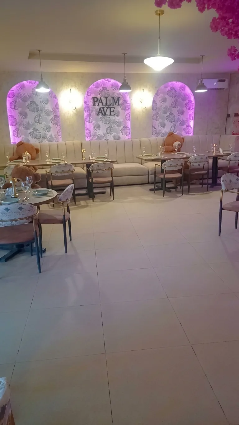 AI-generated image: wide view of the arched wall panels, banquette and dining tables on a tiled floor