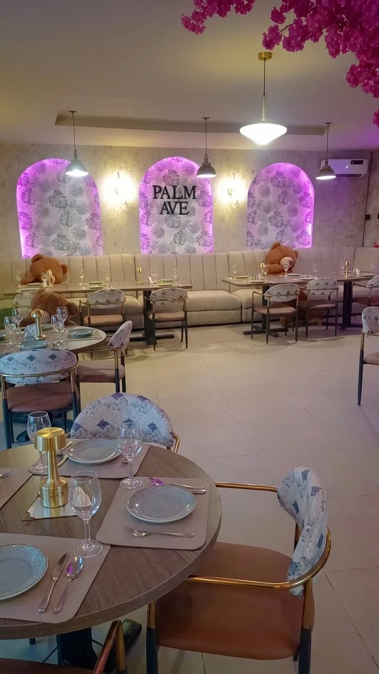 AI-generated image: banquette seating below glowing arched wall panels with a 'Palm Ave' sign